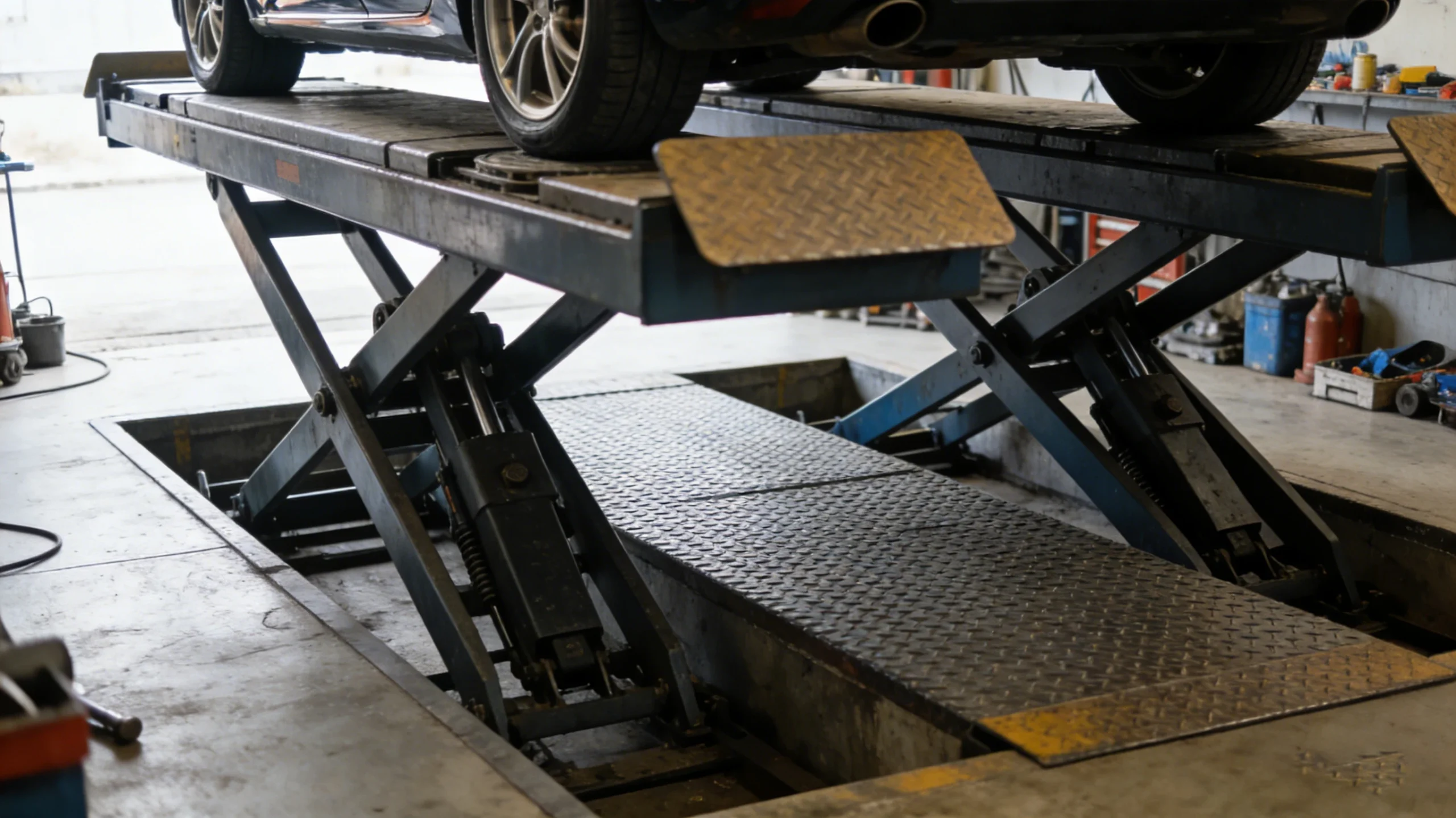 Middle scissor car lift in use with vehicle, hydraulic vehicle lifting equipment in auto repair shop