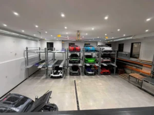 Automated parking system in a luxury garage, with multiple levels of high-performance supercars including Porsches and Lamborghinis.