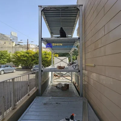 triple-stack-four-post-parking-lift-with-three-luxury-cars-in-indoor-garage