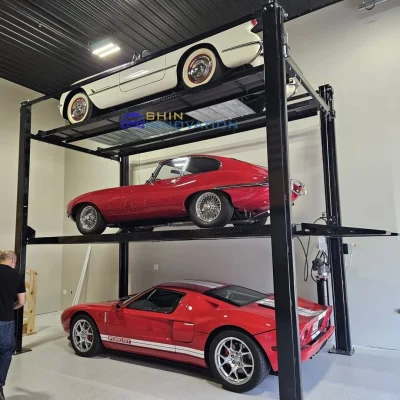 Underground two-post parking lift with blue and red SUVs in a concrete parking garage, demonstrating space-efficient two-level parking.